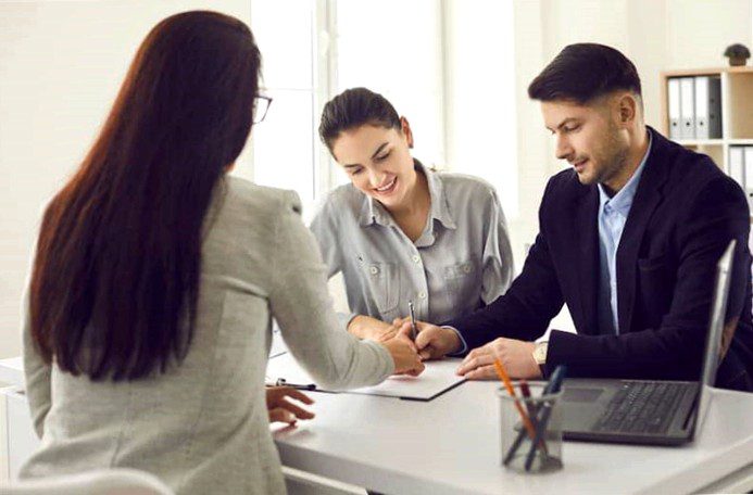 A couple signs up for an annuity loan