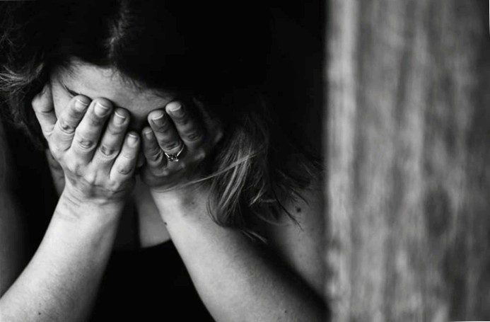 A woman cries after losing her job