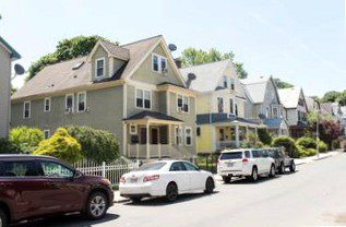 Single-family houses along a sunny street.